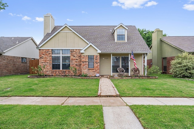 4145 Malone Ave, The Colony, TX 75056 - view of front of home with a porch, a shingled roof, brick siding, and a front yard