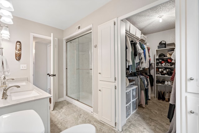 4145 Malone Ave, The Colony, TX 75056 - full bathroom featuring a walk in closet, visible vents, a shower stall, and a sink