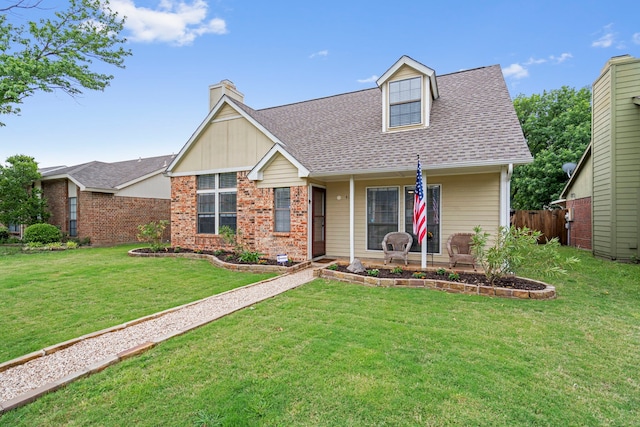 4145 Malone Ave, The Colony, TX 75056 - view of front facade with a chimney, brick siding, fence, a front lawn, and a shingled roof