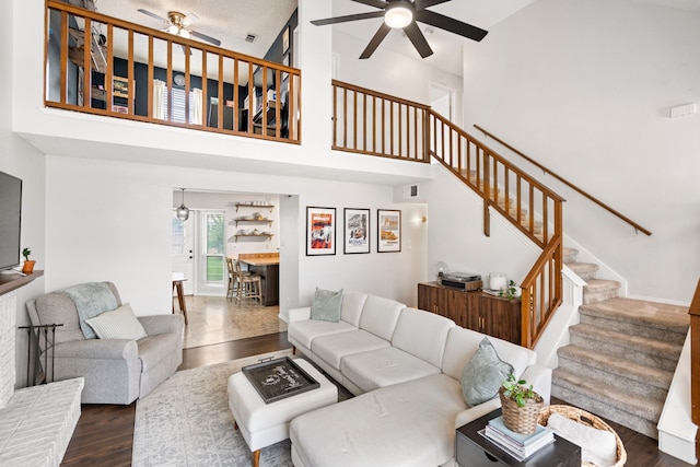 4145 Malone Ave, The Colony, TX 75056 - living room with a ceiling fan, stairs, dark wood-style floors, and a towering ceiling