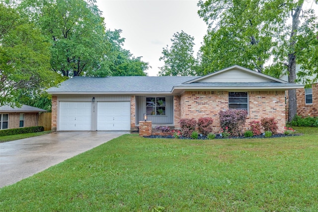 single story home with brick siding, a garage, a front lawn, and concrete driveway
