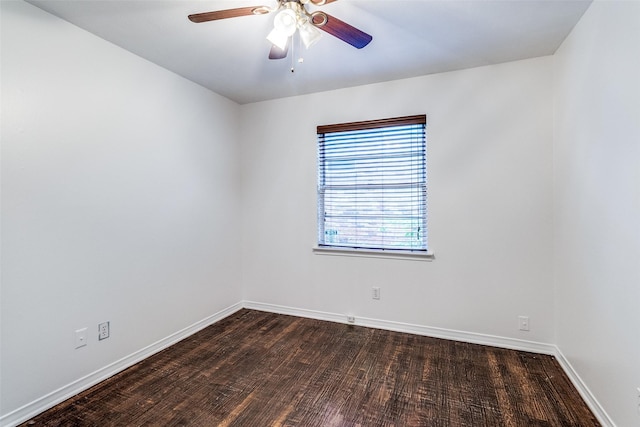 spare room with baseboards, a ceiling fan, and wood finished floors