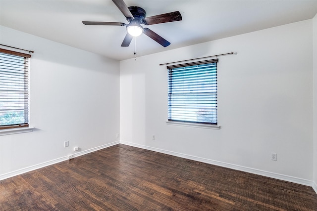 empty room featuring a healthy amount of sunlight, baseboards, a ceiling fan, and wood finished floors