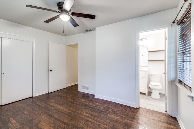 unfurnished bedroom featuring visible vents and wood finished floors