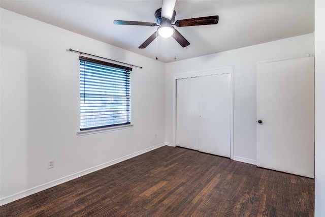 unfurnished bedroom featuring a closet, a ceiling fan, baseboards, and wood finished floors