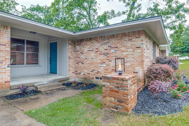 entrance to property with brick siding