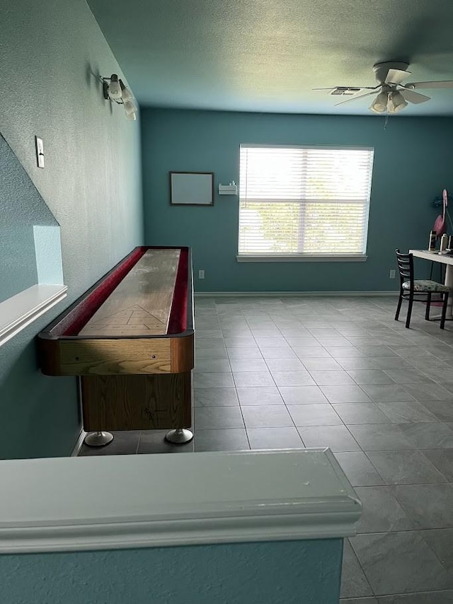 1824 Shady Point Circle Dr, San Angelo, TX 76904 - game room with tile patterned flooring, a ceiling fan, baseboards, and a textured ceiling