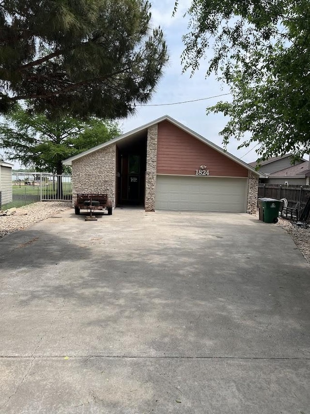 1824 Shady Point Circle Dr, San Angelo, TX 76904 - garage featuring fence and concrete driveway