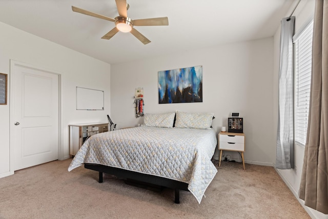 bedroom featuring a ceiling fan and light colored carpet