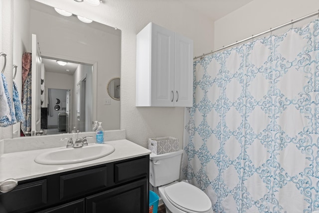 bathroom featuring vanity, toilet, and a shower with curtain