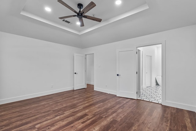 6725 Macintosh Dr, Plano, TX 75023 - unfurnished bedroom with recessed lighting, dark wood finished floors, and a tray ceiling