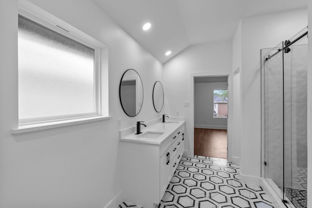 6725 Macintosh Dr, Plano, TX 75023 - bathroom featuring double vanity, a sink, and a stall shower