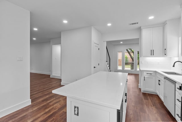 6725 Macintosh Dr, Plano, TX 75023 - kitchen featuring visible vents, dark wood-style flooring, a center island, a sink, and dishwasher