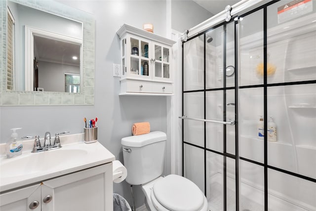 bathroom featuring vanity, toilet, and a shower stall