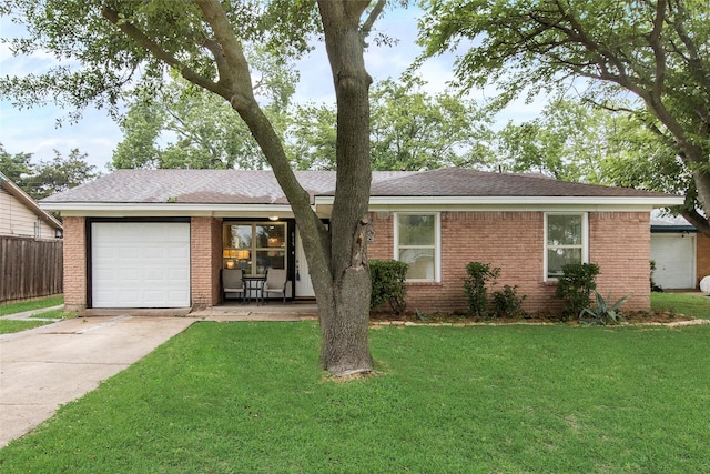 ranch-style house with an attached garage, driveway, brick siding, and a front yard