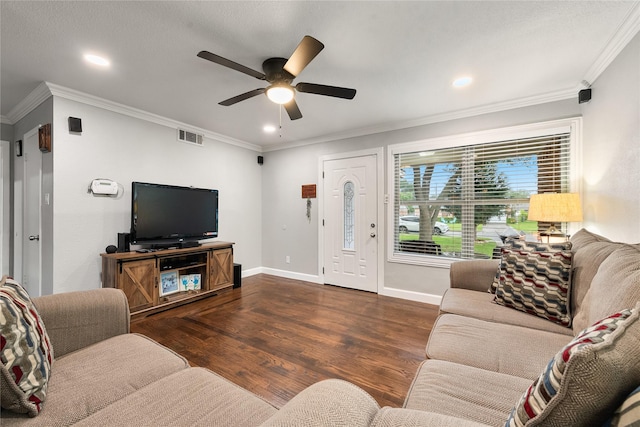 living room with crown molding, a ceiling fan, visible vents, and wood finished floors