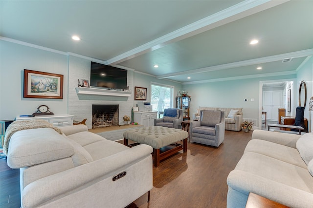 living room featuring recessed lighting, dark wood-style floors, ornamental molding, and a fireplace