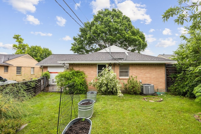 9661 Lynbrook Dr, Dallas, TX 75238 - rear view of house featuring fence, roof with shingles, central air condition unit, brick siding, and a lawn