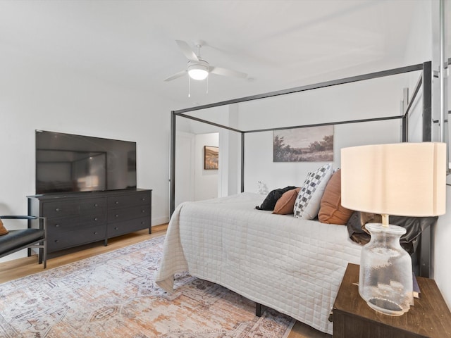 bedroom with ceiling fan and wood finished floors