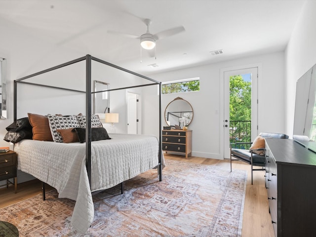 bedroom with access to outside, a ceiling fan, light wood finished floors, and visible vents
