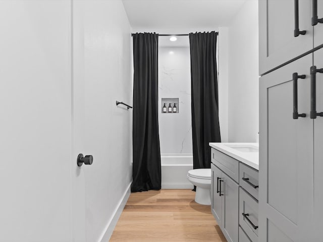 full bathroom featuring shower / bath combo, wood finished floors, vanity, toilet, and recessed lighting