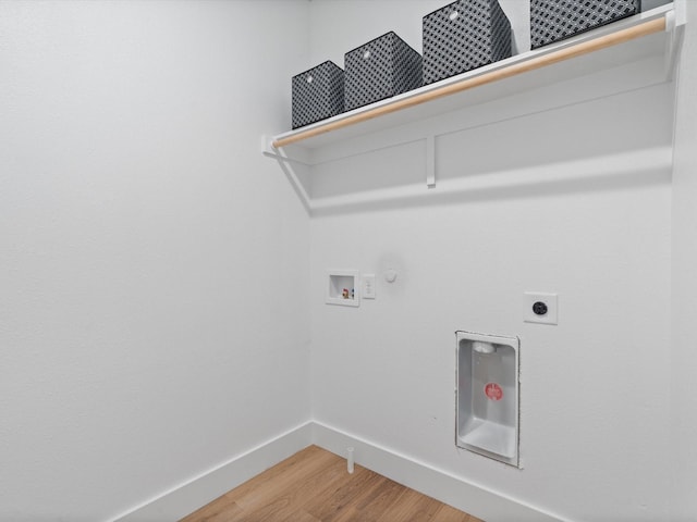 laundry area with laundry area, washer hookup, light wood finished floors, baseboards, and hookup for an electric dryer