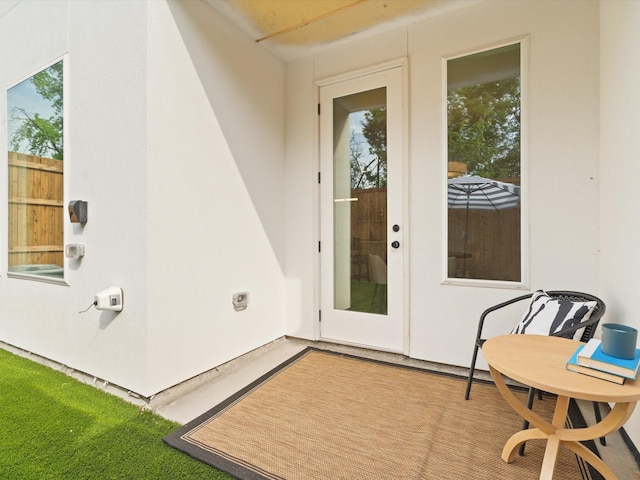 entrance to property with stucco siding