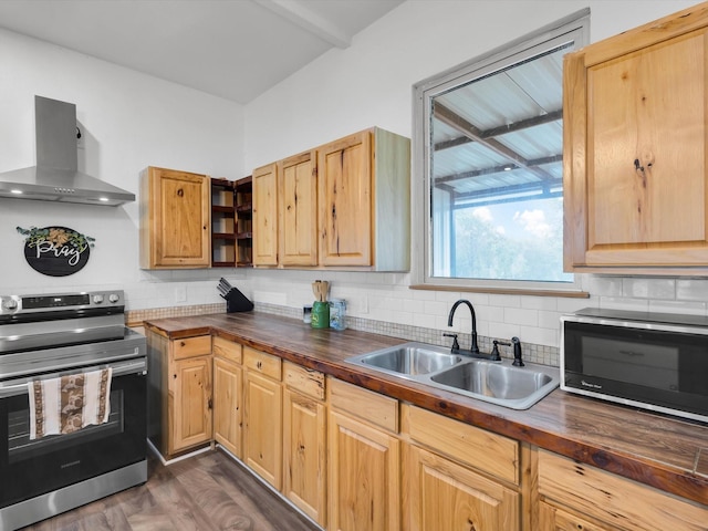 kitchen featuring a sink, stainless steel electric range, wall chimney exhaust hood, and butcher block counters