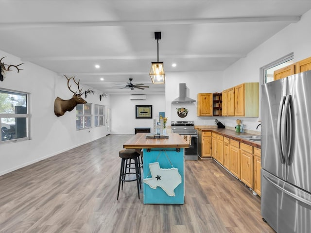 kitchen with beam ceiling, a sink, wall chimney exhaust hood, stainless steel appliances, and butcher block counters