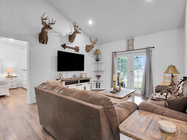 living area with recessed lighting, french doors, lofted ceiling, and light wood-style floors