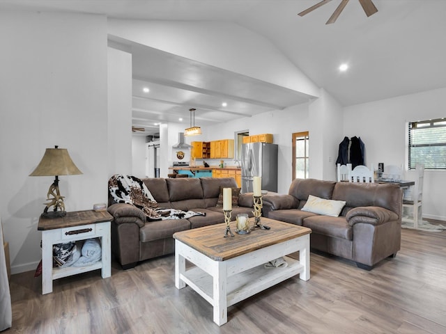 living room featuring light wood-style floors, ceiling fan, vaulted ceiling, and recessed lighting