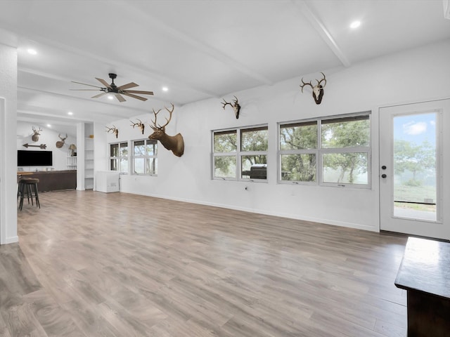 unfurnished living room with ceiling fan, beam ceiling, baseboards, light wood-style floors, and recessed lighting