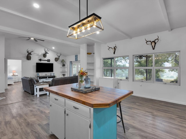 kitchen with white cabinetry, wooden counters, vaulted ceiling with beams, and dark wood-type flooring