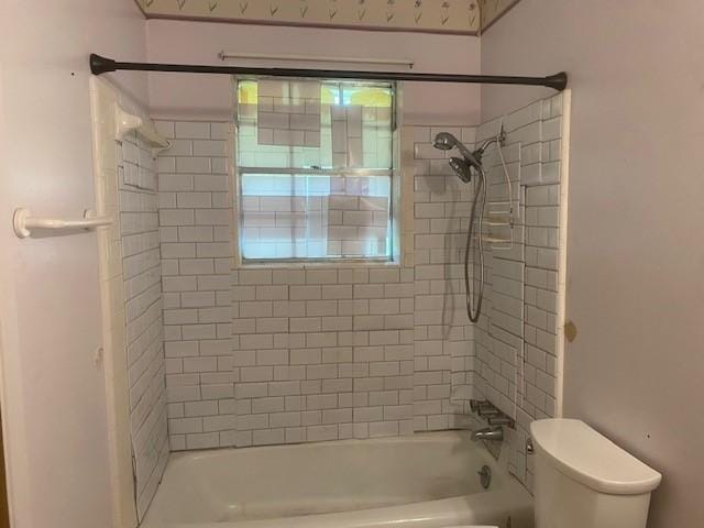 bathroom with tub / shower combination and toilet