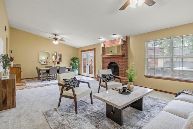 living area with ceiling fan, light carpet, and baseboards