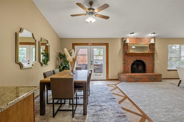 dining area with a healthy amount of sunlight, light tile patterned floors, french doors, and lofted ceiling
