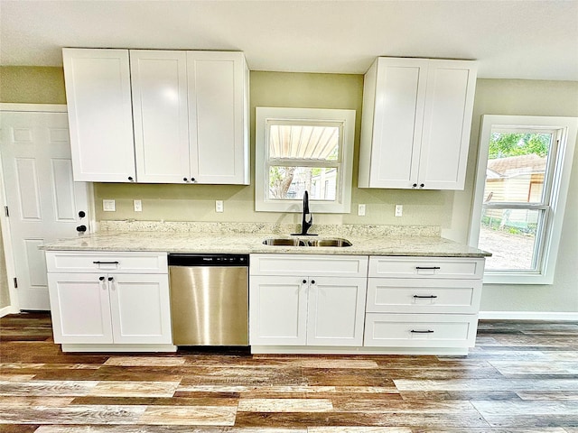 kitchen with a sink, light stone countertops, white cabinetry, and dishwasher