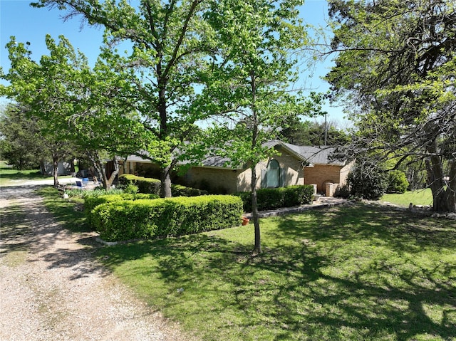 view of home's exterior featuring a yard and brick siding
