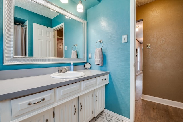 bathroom with vanity and wood finished floors