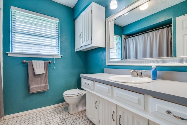 full bathroom with toilet, baseboards, a shower with shower curtain, tile patterned floors, and vanity