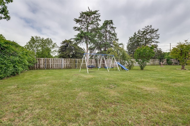 view of yard featuring a playground and a fenced backyard