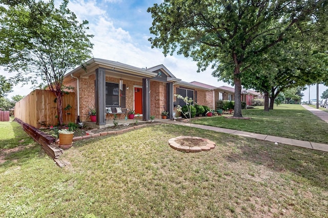 single story home with brick siding, fence, a front yard, and a porch
