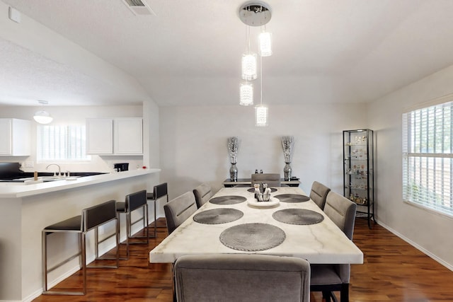 dining area with baseboards, visible vents, and dark wood-style floors