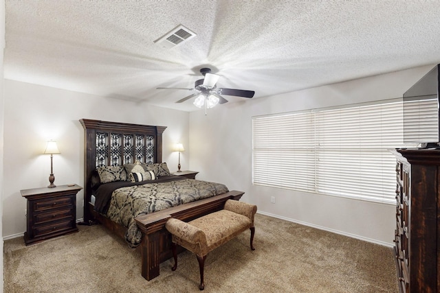 bedroom featuring a ceiling fan, baseboards, visible vents, and light carpet