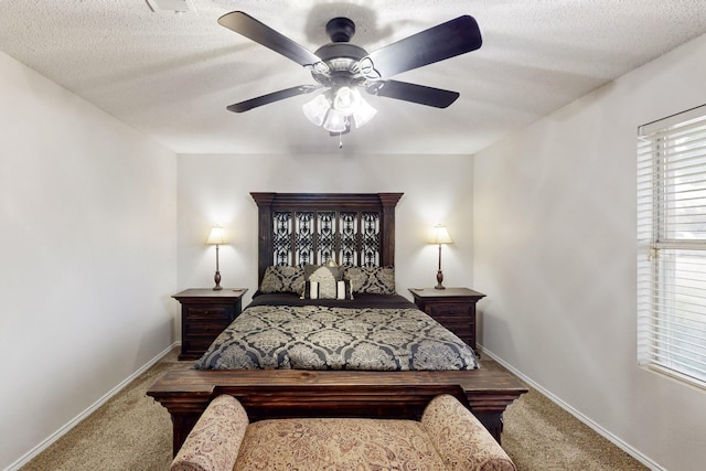 bedroom featuring a textured ceiling, baseboards, a ceiling fan, and carpet