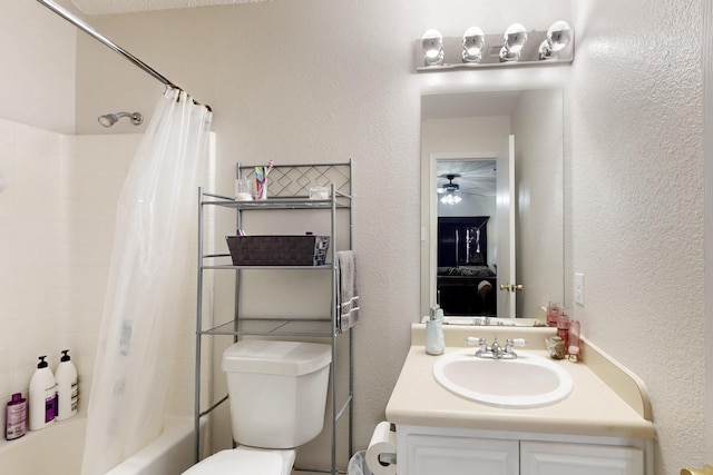full bathroom featuring ceiling fan, shower / bath combination with curtain, vanity, toilet, and a textured wall