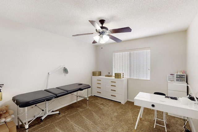 carpeted office space featuring a textured ceiling, ceiling fan, and baseboards