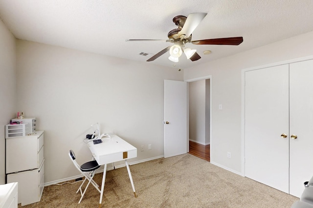 carpeted bedroom featuring visible vents, a ceiling fan, baseboards, and a closet