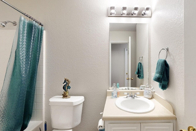 full bathroom featuring toilet, a textured wall, shower / bath combo with shower curtain, and vanity