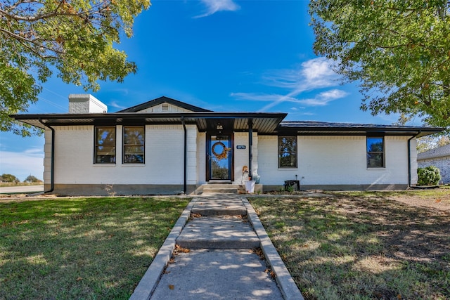 1076 N Cedar St, Muenster, TX 76252 - view of front of house with a chimney, a front lawn, and brick siding